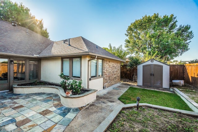 rear view of house featuring a patio area and a shed