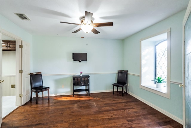 sitting room featuring ceiling fan and dark hardwood / wood-style flooring