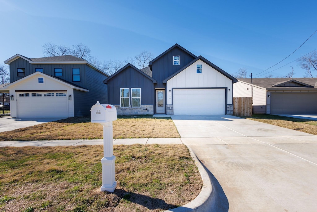 view of front of house with a garage and a front lawn