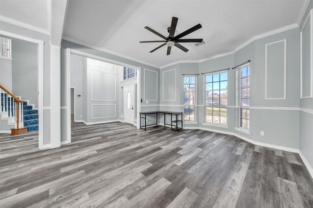 unfurnished living room featuring ceiling fan, ornamental molding, and wood-type flooring