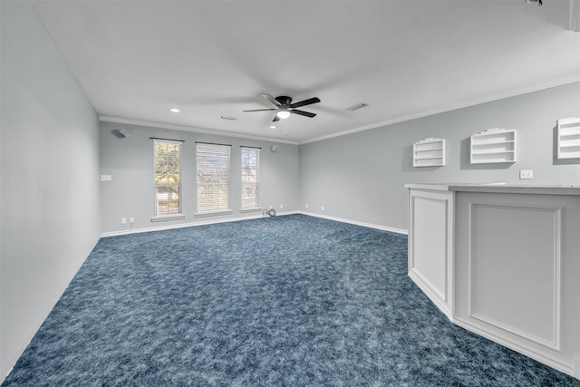 spare room with dark colored carpet, ceiling fan, and crown molding