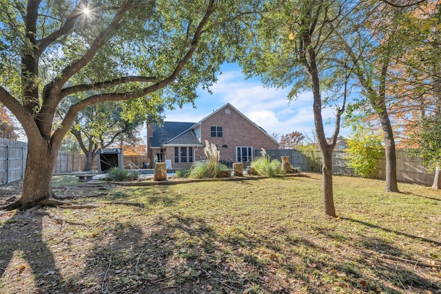 rear view of property with a yard