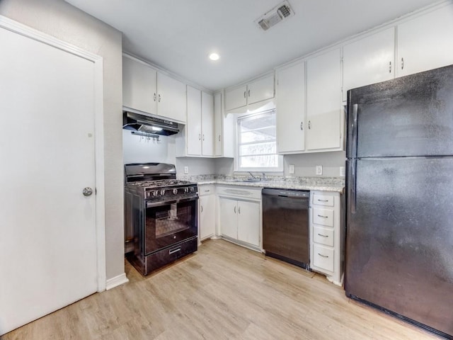 kitchen with sink, white cabinets, black appliances, and light hardwood / wood-style floors