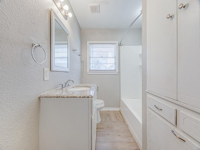 full bathroom featuring shower / bathing tub combination, vanity, toilet, and hardwood / wood-style flooring