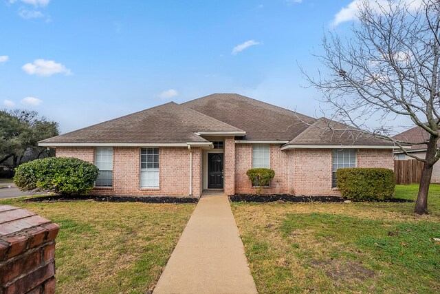 ranch-style home with a front lawn