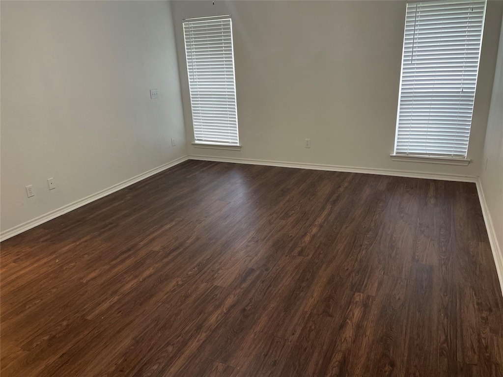 unfurnished room featuring dark wood-type flooring