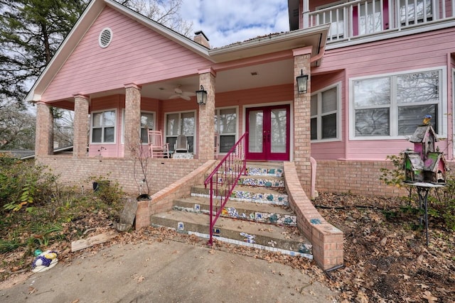 view of front facade with french doors and covered porch