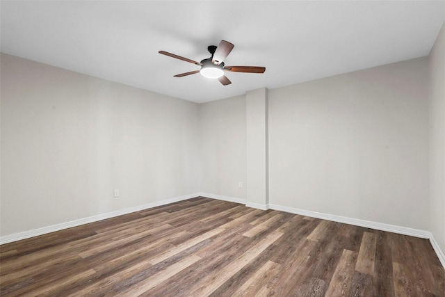 empty room with dark hardwood / wood-style floors and ceiling fan