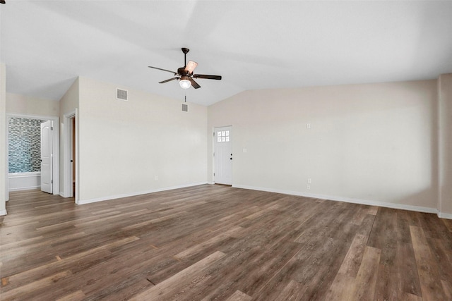 empty room with lofted ceiling, dark hardwood / wood-style floors, and ceiling fan