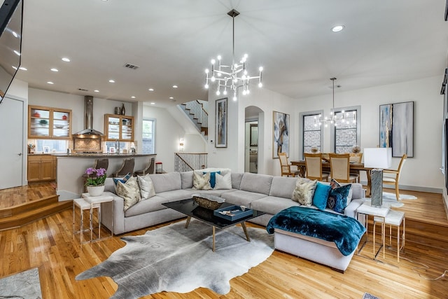 living room featuring light hardwood / wood-style floors and a notable chandelier