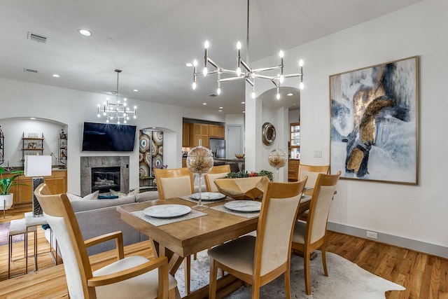 dining room with a chandelier and light hardwood / wood-style floors