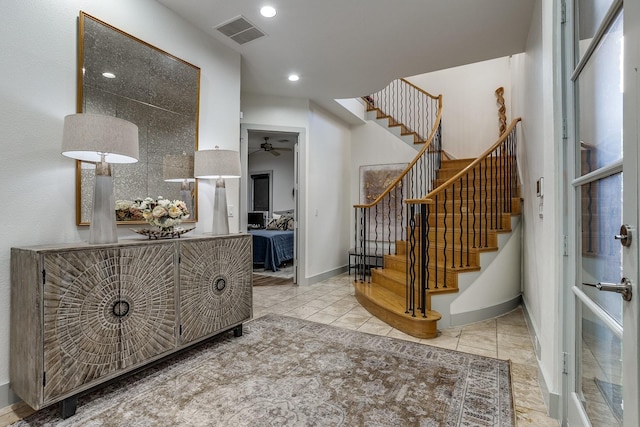 tiled entryway with ceiling fan