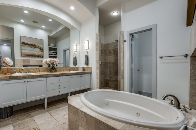 bathroom featuring plus walk in shower and vanity