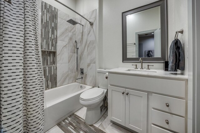 full bathroom featuring vanity, toilet, and tiled shower / bath