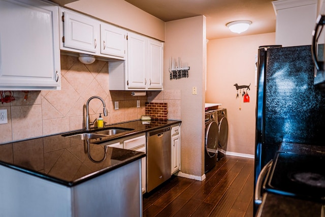 kitchen with black appliances, white cabinetry, sink, and washer and dryer