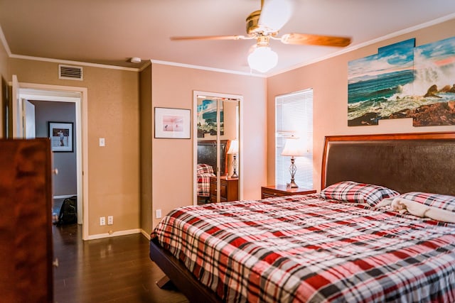 bedroom with ceiling fan, a closet, crown molding, and dark wood-type flooring