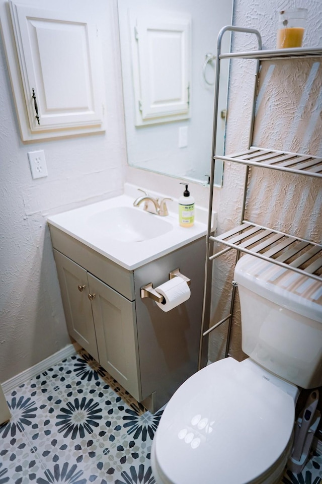 bathroom featuring tile patterned floors, vanity, and toilet