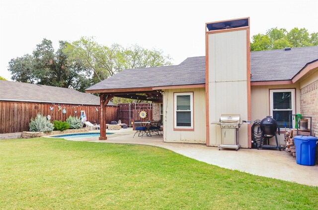 rear view of property with a fenced in pool, a yard, and a patio