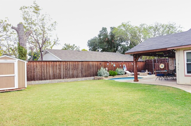 rear view of house with a fenced in pool, a lawn, and a patio