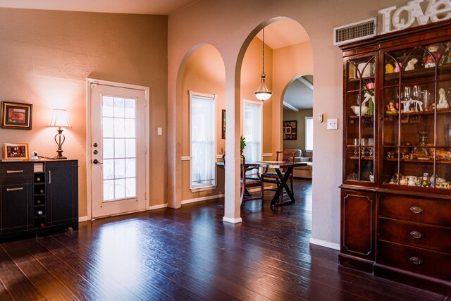 entryway with lofted ceiling and dark hardwood / wood-style floors