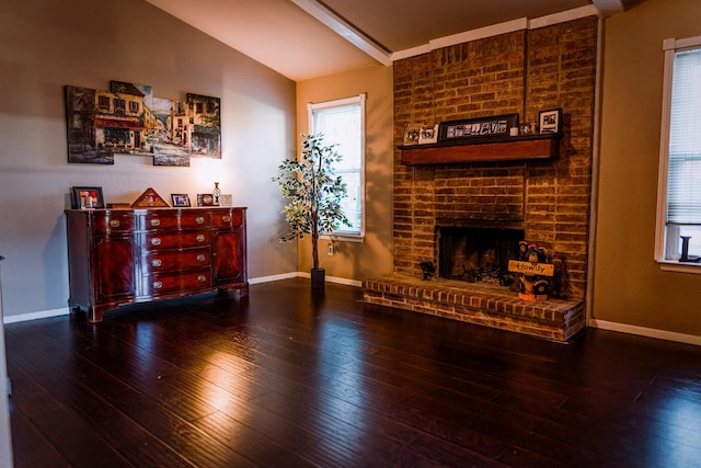 living room with a fireplace, hardwood / wood-style flooring, and vaulted ceiling