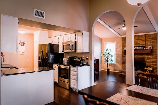 kitchen featuring backsplash, stainless steel appliances, ceiling fan, sink, and white cabinetry