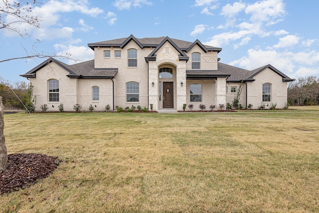 french country home with a front lawn