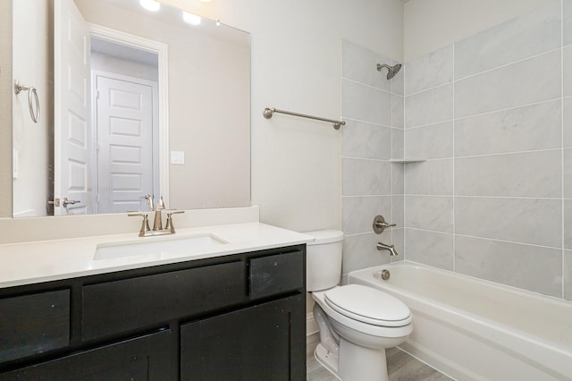 full bathroom with toilet, vanity, hardwood / wood-style flooring, and tiled shower / bath combo