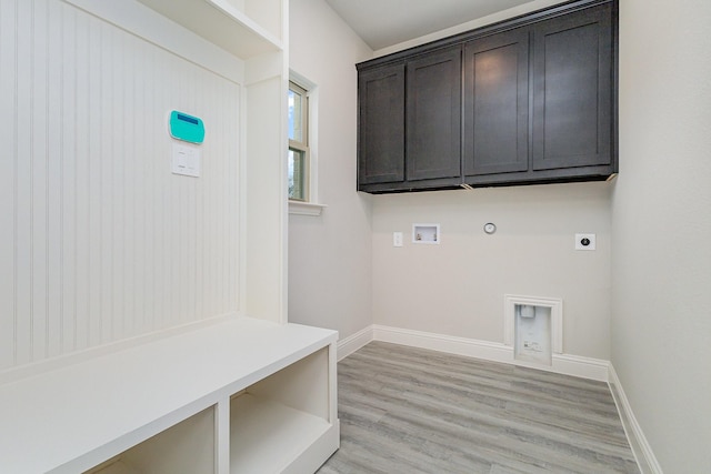 laundry room featuring washer hookup, cabinets, hookup for an electric dryer, gas dryer hookup, and light hardwood / wood-style floors