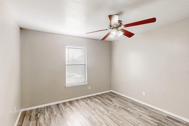 empty room with ceiling fan and light wood-type flooring