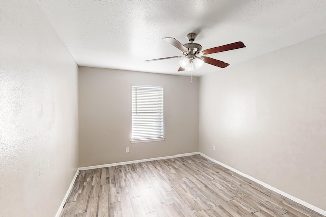 empty room featuring ceiling fan, a textured ceiling, and light wood-type flooring