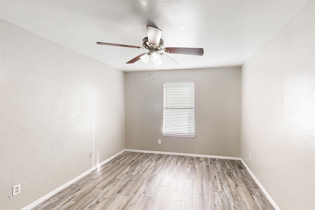 unfurnished room with ceiling fan, a textured ceiling, and light wood-type flooring