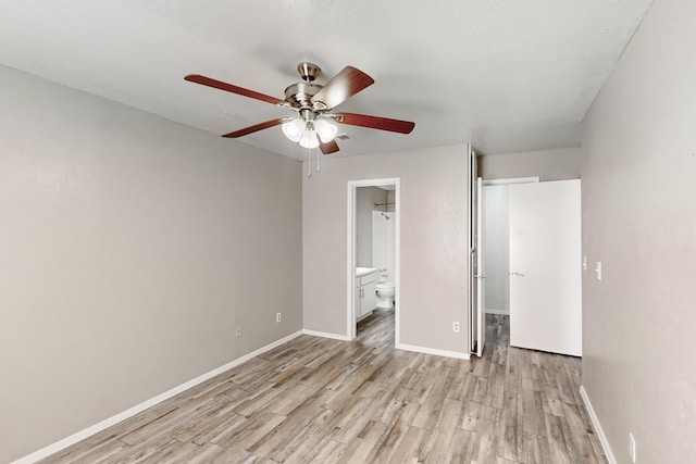 unfurnished bedroom featuring ceiling fan, ensuite bath, and light hardwood / wood-style floors