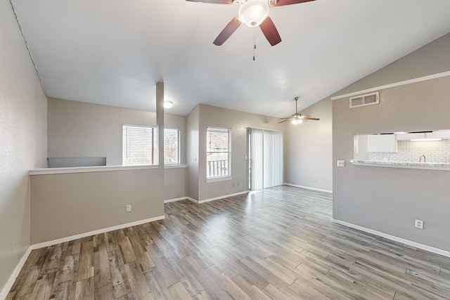 unfurnished room featuring vaulted ceiling, ceiling fan, and light wood-type flooring