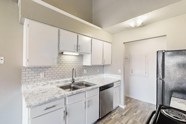 kitchen with sink, dishwasher, backsplash, white cabinets, and black fridge