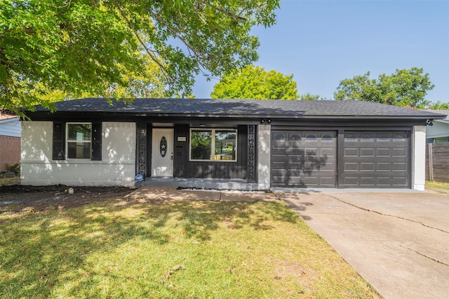 ranch-style home with a garage and a front yard