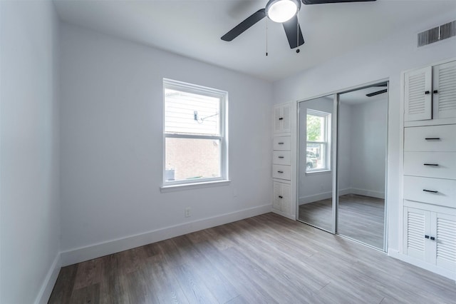 unfurnished bedroom featuring ceiling fan, a closet, and light hardwood / wood-style floors