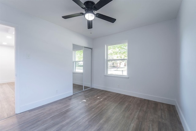 empty room featuring ceiling fan and dark wood-type flooring