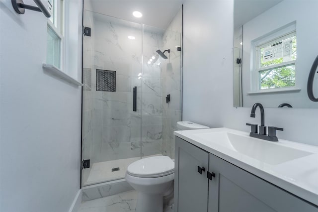 bathroom with vanity, toilet, and an enclosed shower