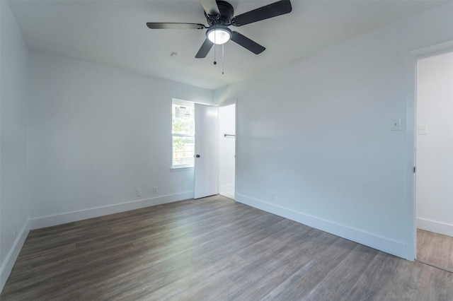 spare room featuring ceiling fan and dark wood-type flooring