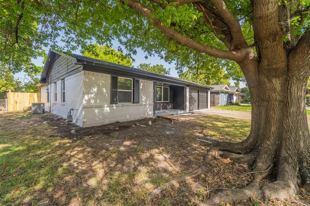 view of front of home featuring central AC unit and a garage