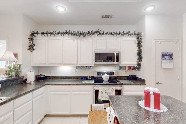 kitchen featuring white cabinetry, appliances with stainless steel finishes, and light tile patterned floors