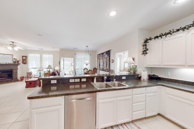 kitchen featuring dishwasher, sink, and white cabinets