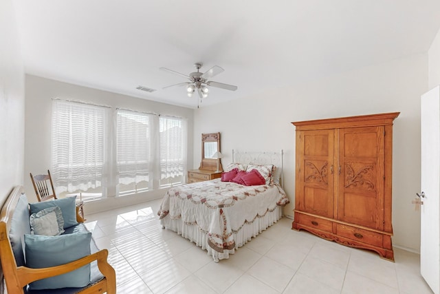 tiled bedroom with ceiling fan