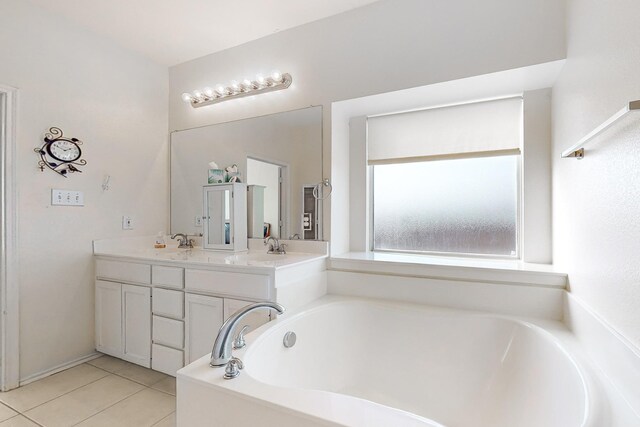 bathroom with tile patterned flooring, vanity, and a bath