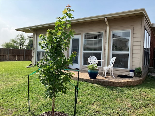 rear view of property featuring a yard