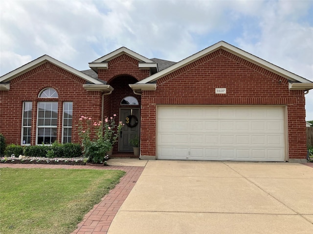 view of property featuring a garage and a front yard