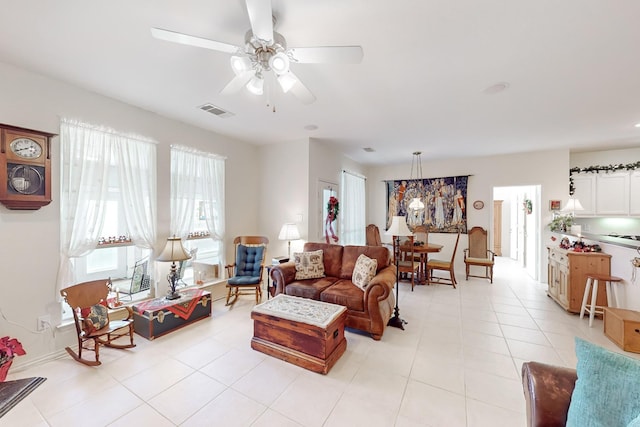 living room featuring light tile patterned floors and ceiling fan