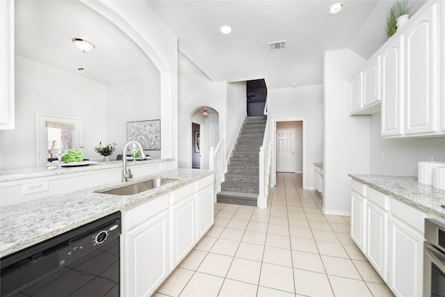 kitchen with white cabinetry, black dishwasher, sink, and light stone countertops