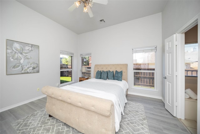 bedroom with lofted ceiling, wood-type flooring, and ceiling fan